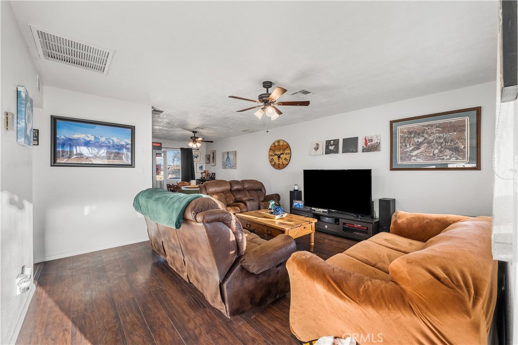13336 Clement Edwards, CA 93523 - Photo 2 of 56 a living room with furniture a fireplace and a flat screen tv