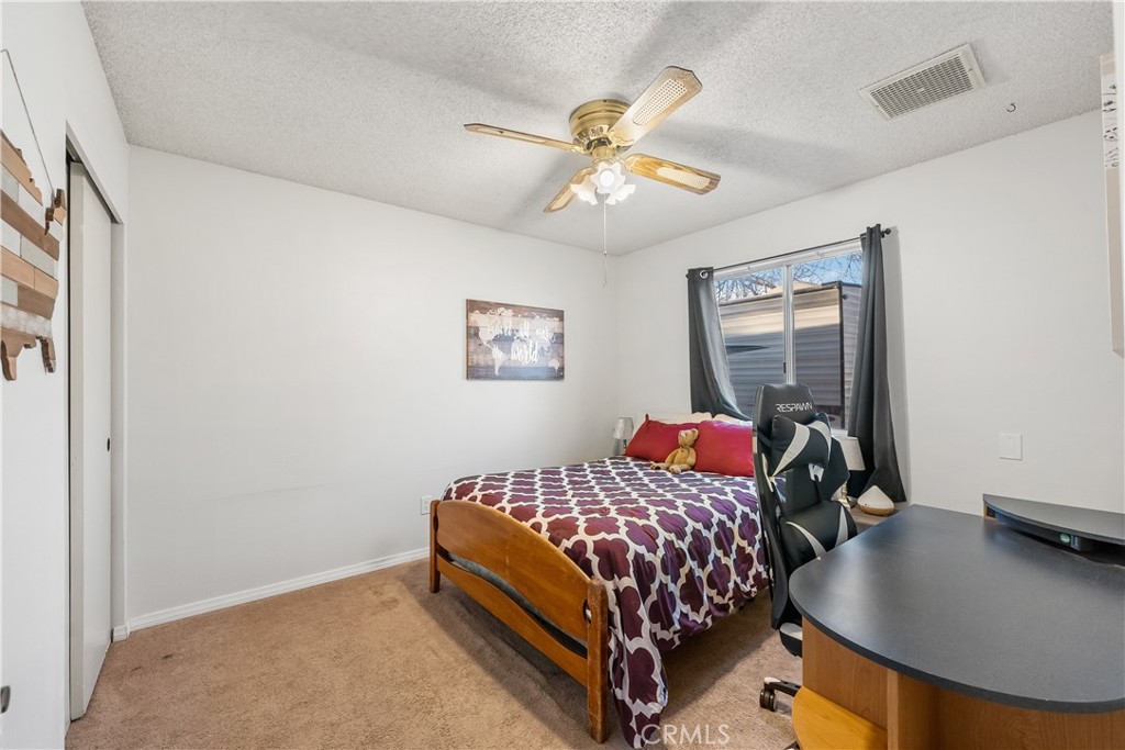 13336 Clement Edwards, CA 93523 - Photo 22 of 56 a bedroom with a bed and a chandelier