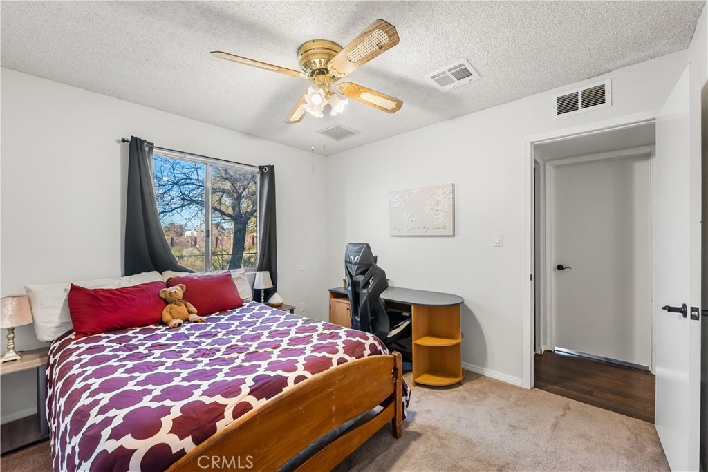 13336 Clement Edwards, CA 93523 - Photo 23 of 56 a bedroom with a bed and a chandelier