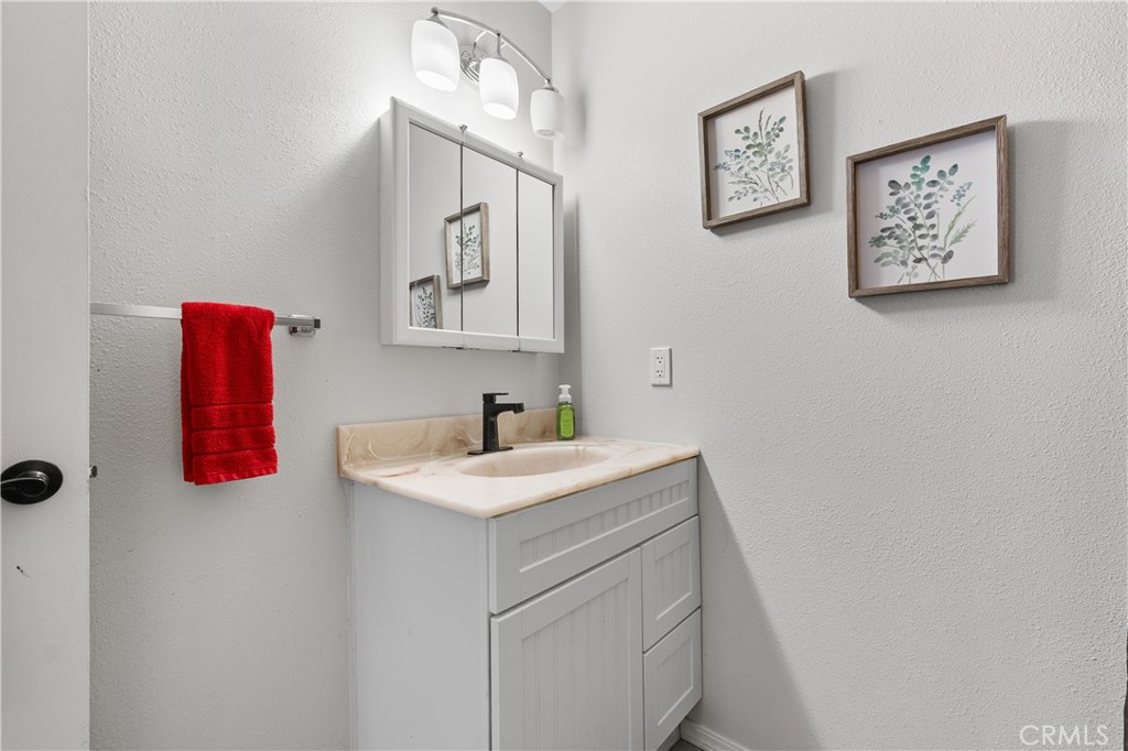 13336 Clement Edwards, CA 93523 - Photo 28 of 56 a bathroom with a sink vanity and a mirror