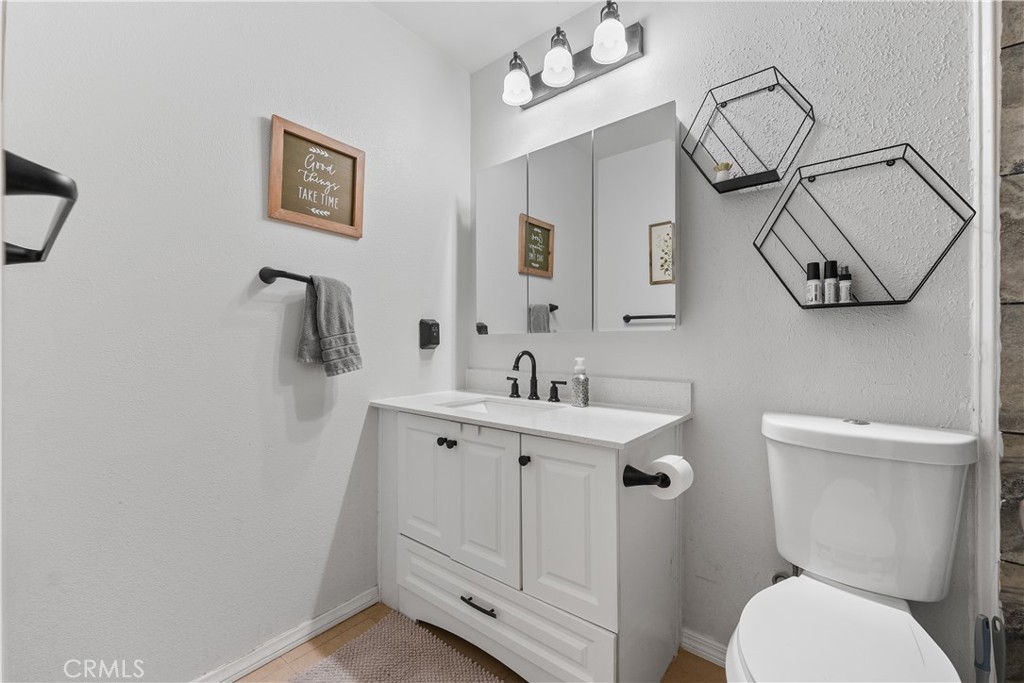 13336 Clement Edwards, CA 93523 - Photo 29 of 56 a bathroom with a toilet sink and mirror