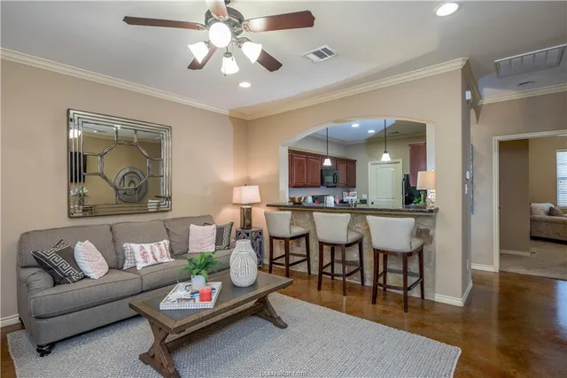 a living room with furniture and view of kitchen