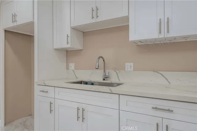 a kitchen with white cabinets