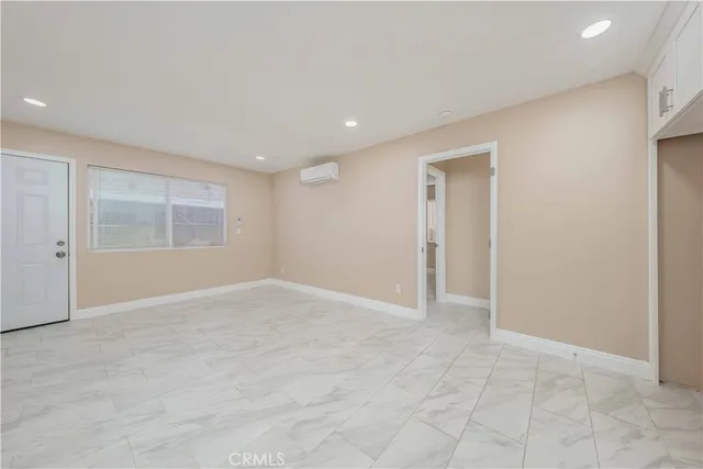 an empty room with windows and closet