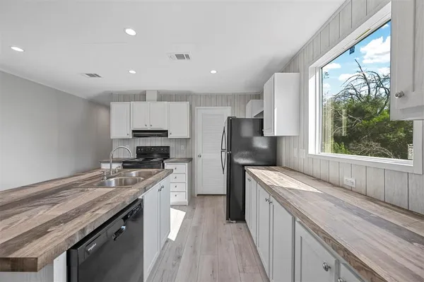 a kitchen with a sink stove and refrigerator