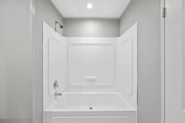 a white bath tub sitting next to a white sink