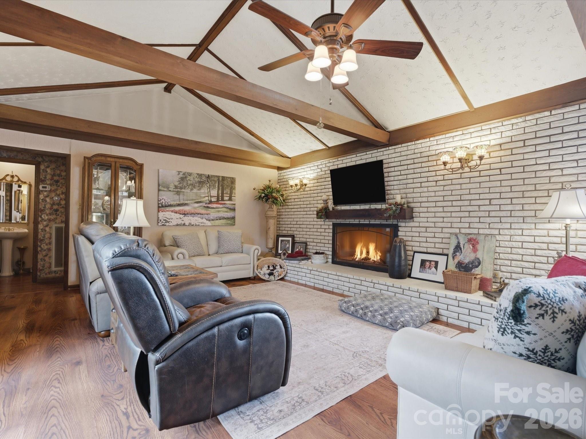 2620 Reeves Island Road Gold Hill, NC 28071 - Photo 19 of 48 a living room with furniture a flat screen tv and a fireplace