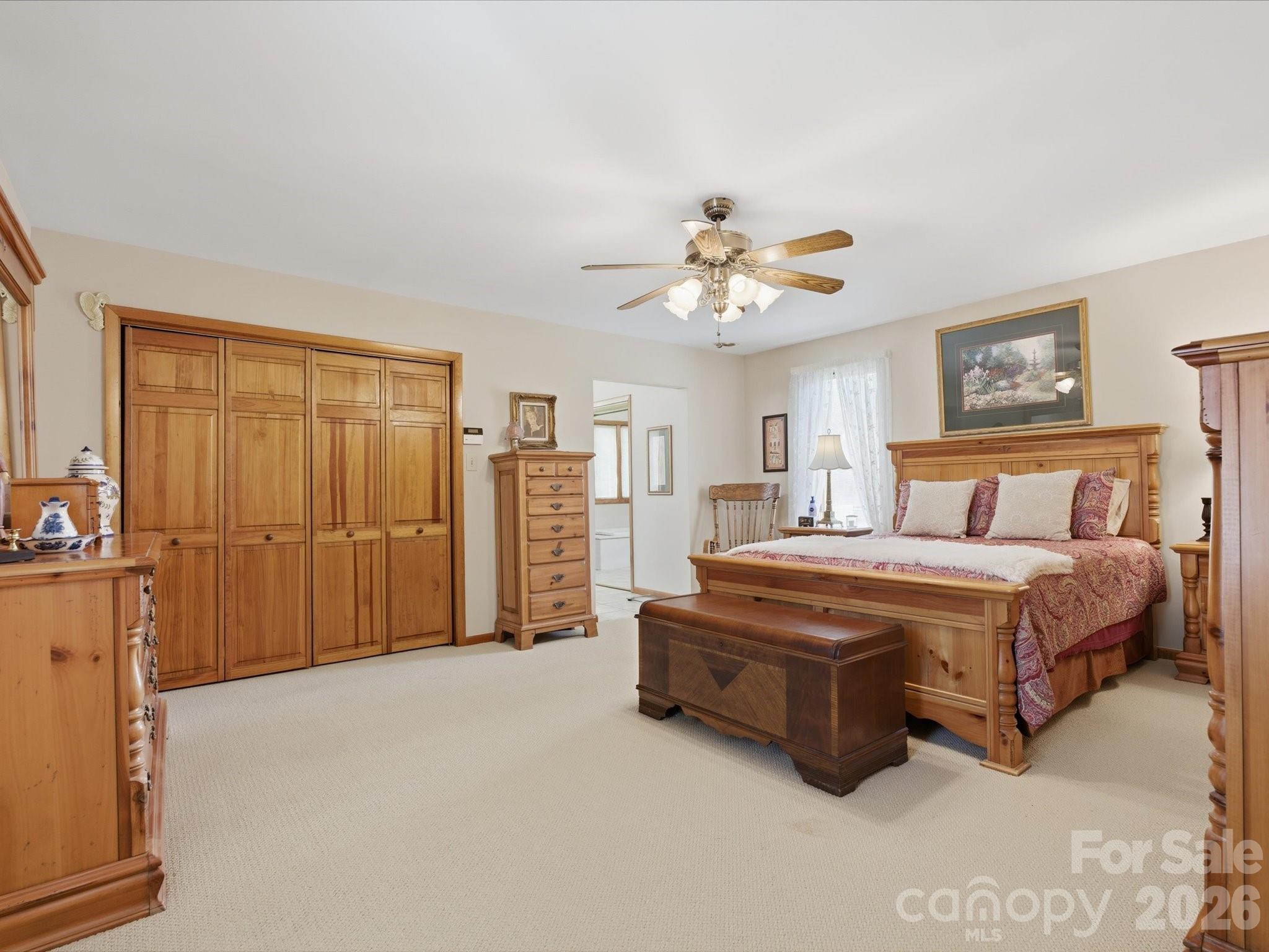 2620 Reeves Island Road Gold Hill, NC 28071 - Photo 23 of 48 a spacious bedroom with a bed and a chandelier