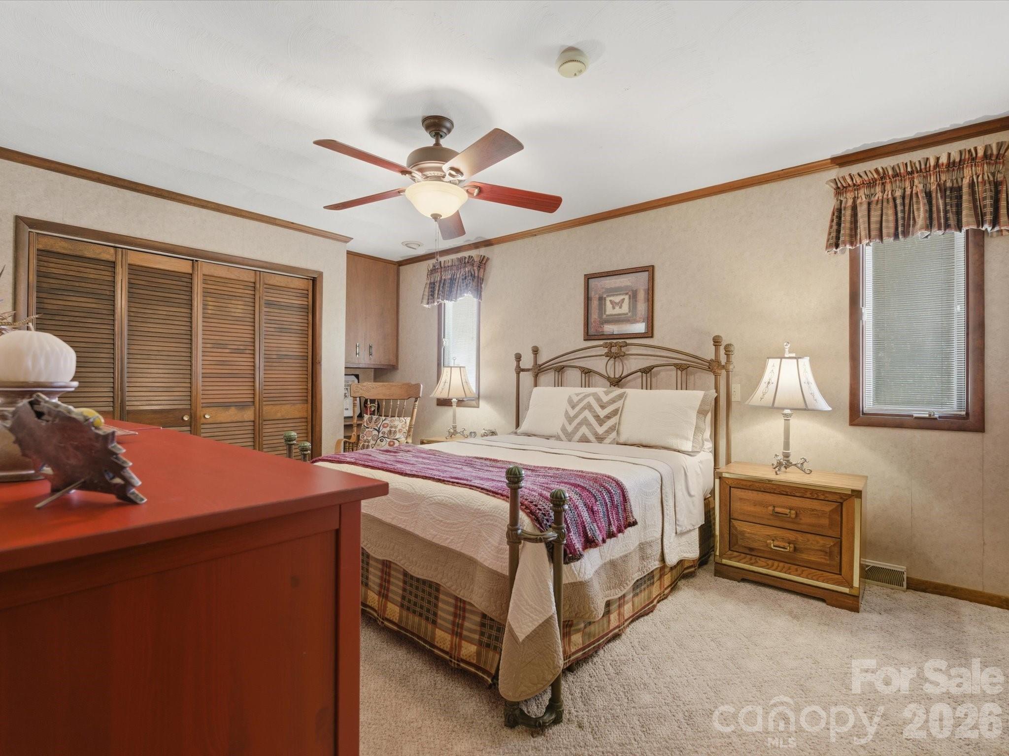 2620 Reeves Island Road Gold Hill, NC 28071 - Photo 28 of 48 a bedroom with a bed and a chandelier