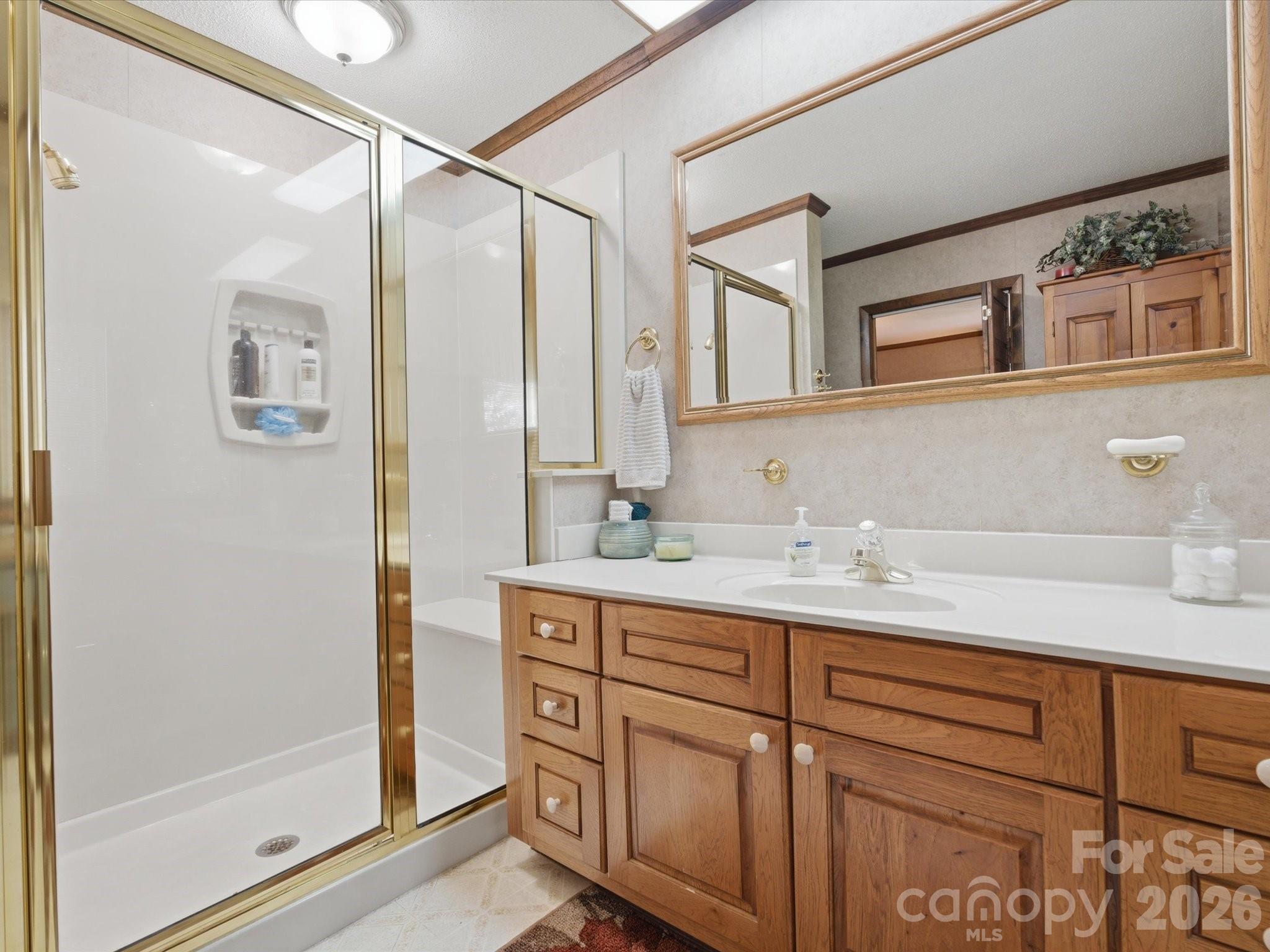 2620 Reeves Island Road Gold Hill, NC 28071 - Photo 30 of 48 a bathroom with a granite countertop sink and a mirror