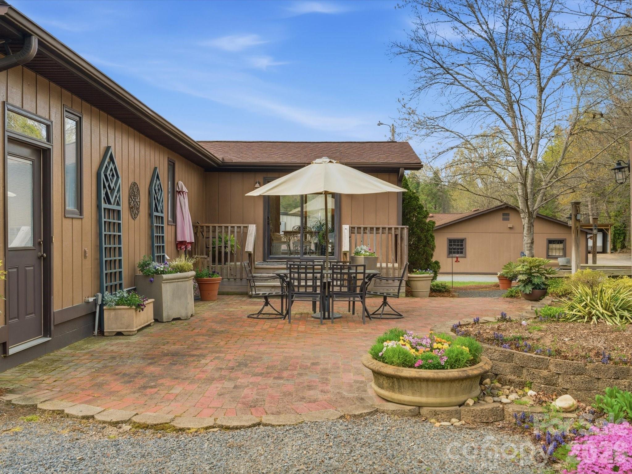 2620 Reeves Island Road Gold Hill, NC 28071 - Photo 5 of 48 a patio with a table and chairs and a potted plants