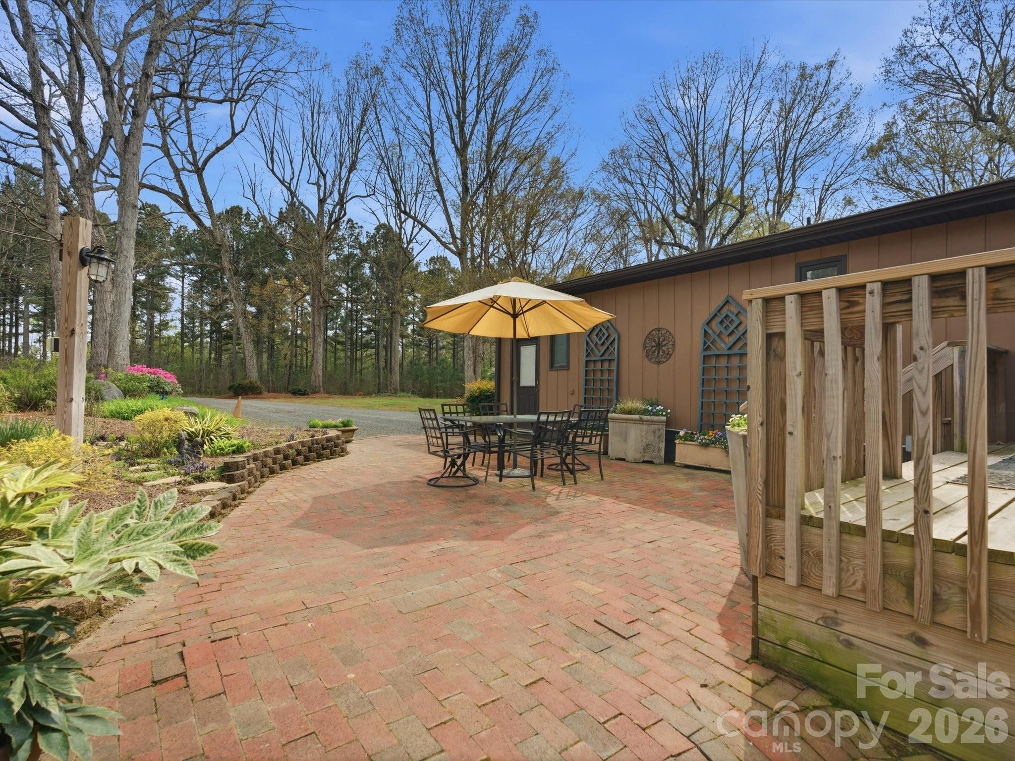2620 Reeves Island Road Gold Hill, NC 28071 - Photo 6 of 48 a view of a patio with a table and chairs under an umbrella