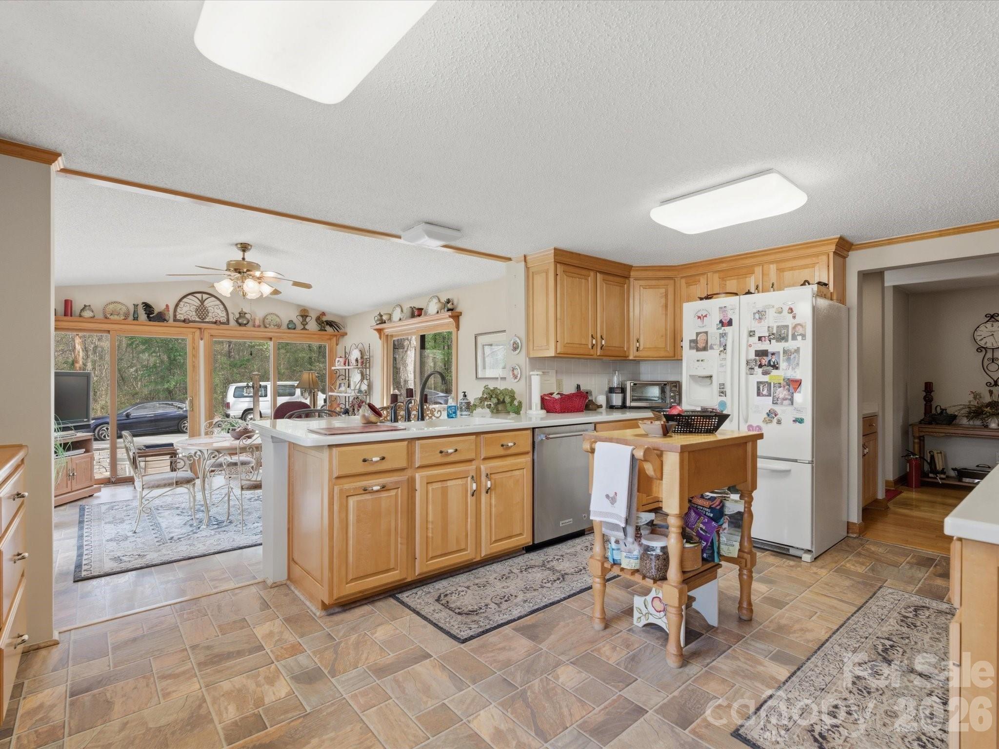 2620 Reeves Island Road Gold Hill, NC 28071 - Photo 9 of 48 a kitchen with granite countertop sink dining table and chairs