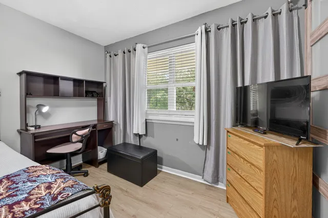 a bathroom with a sink toilet vanity and shower