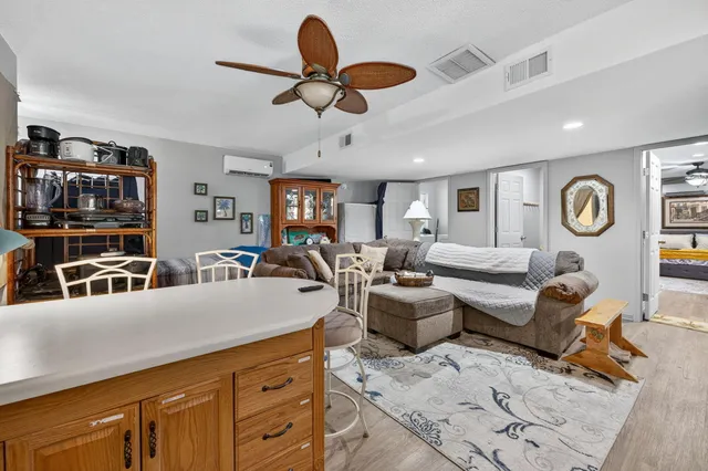 a spacious bedroom with a bed and a flat screen tv