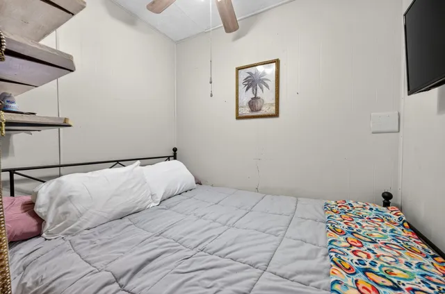 a view of a roof deck with table and chairs under an umbrella with wooden floor