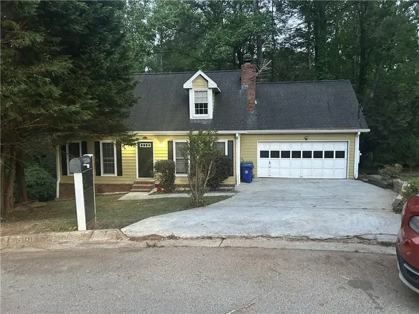 a view of a house with a yard and garage