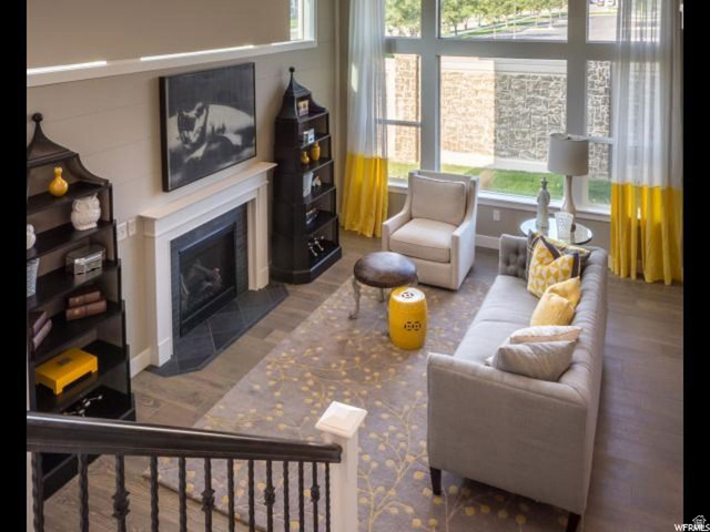 9294 South Rose Cottage Way, Unit 207 Sandy, UT 84094 - Photo 7 of 10 Living area featuring a fireplace with flush hearth and wood finished floors