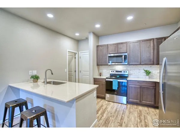 a kitchen with a sink appliances and cabinets