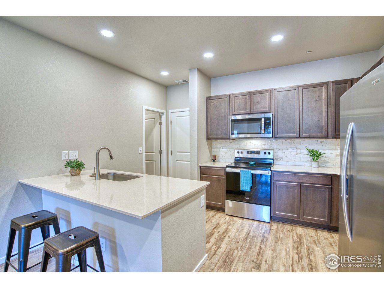 a kitchen with a sink appliances and cabinets