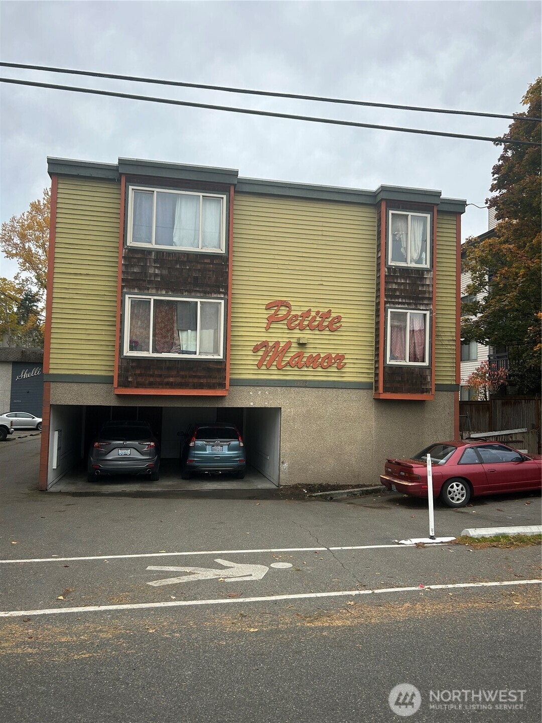 a black car parked in front of a house