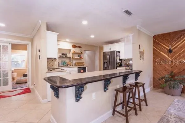 a kitchen with stainless steel appliances granite countertop a sink and a refrigerator