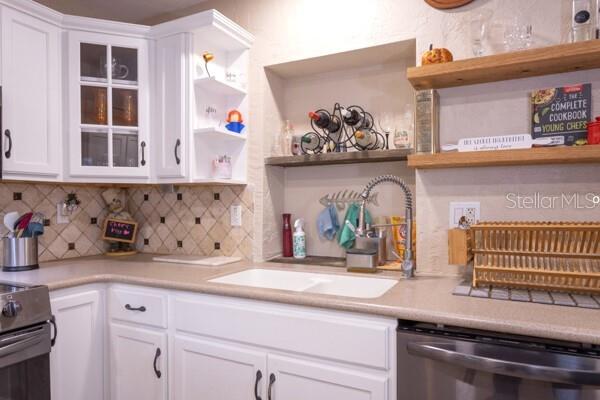 504 North Cherry Street Bunnell, FL 32110 - Photo 14 of 40 a kitchen with a sink and cabinets