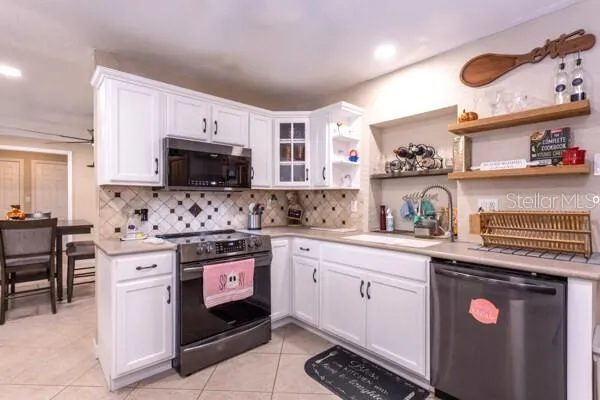 a kitchen with granite countertop a sink stainless steel appliances and cabinets