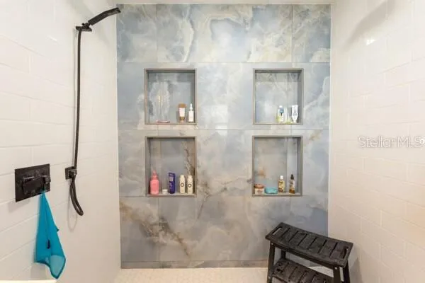 a view of living room with furniture and a mirror