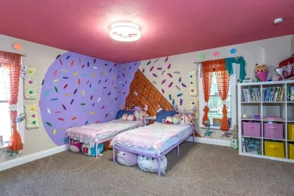 a spacious bedroom with a bed and a dresser in it