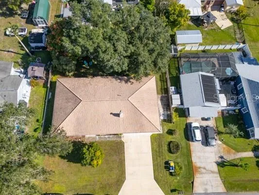 an aerial view of a pool patio outdoor seating and yard