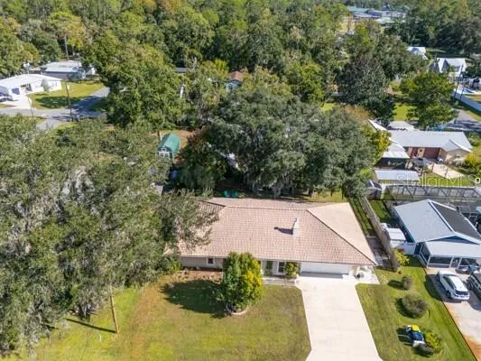 an aerial view of a house with yard swimming pool and outdoor seating