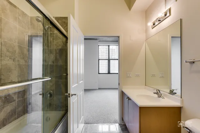 a bathroom with a sink toilet and mirror