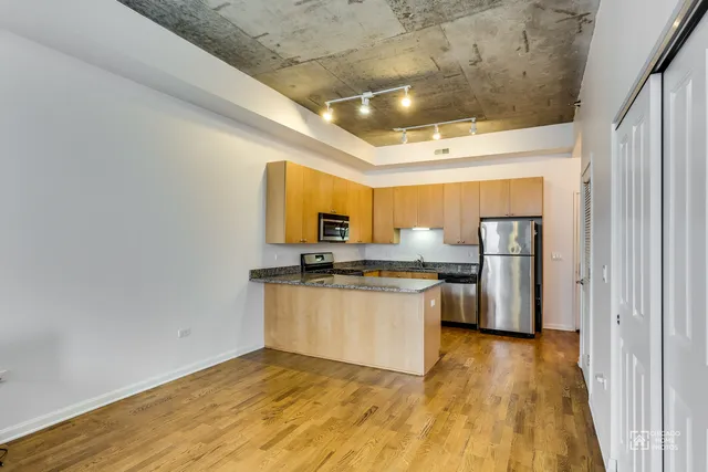 a kitchen with stainless steel appliances a sink a stove top oven a counter space and cabinets