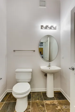 a bathroom with a sink a toilet and mirror