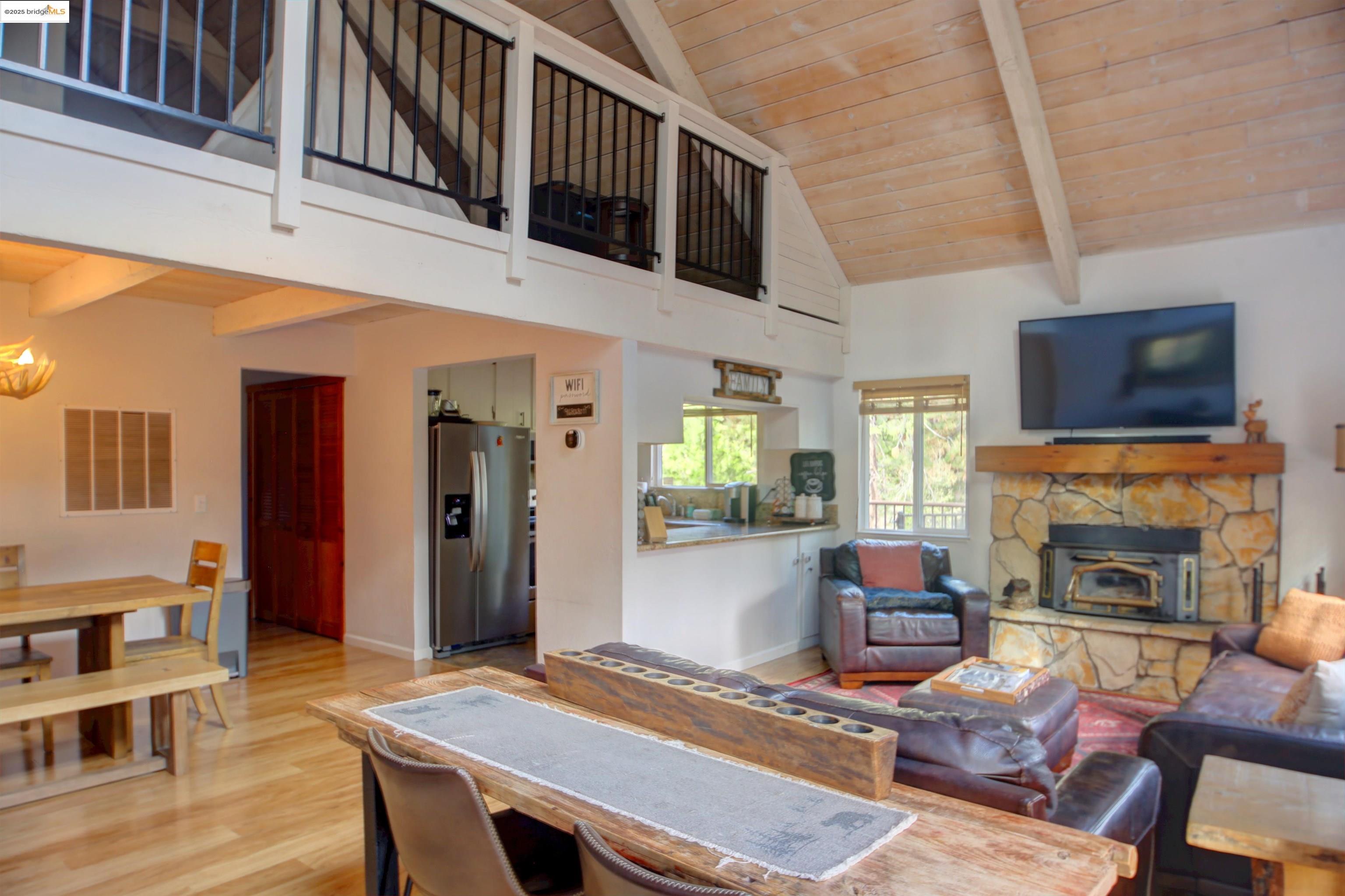 11979 Myer Court Groveland, CA 95321 - Photo 17 of 39 a living room with furniture a fireplace and a flat screen tv
