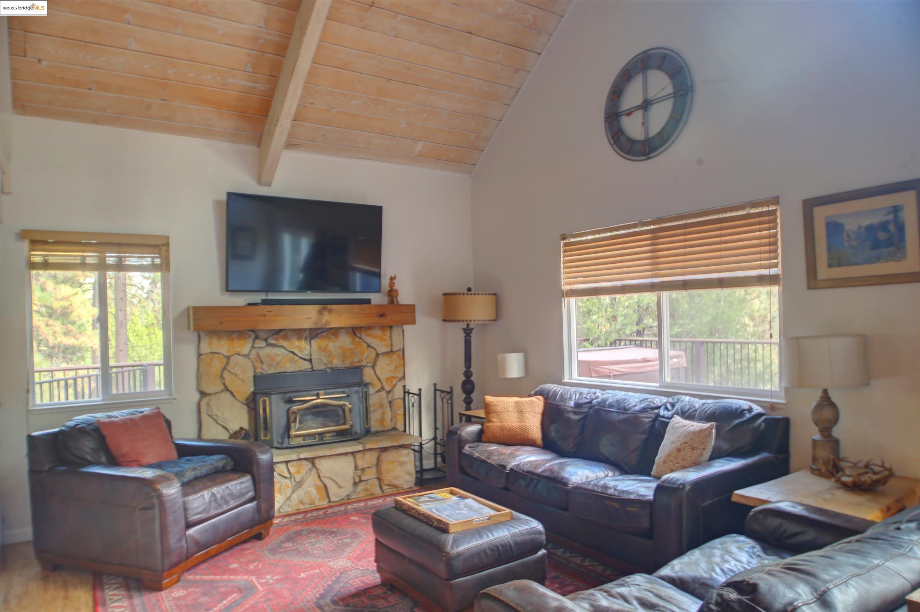 11979 Myer Court Groveland, CA 95321 - Photo 18 of 39 a living room with furniture a flat screen tv and a fireplace