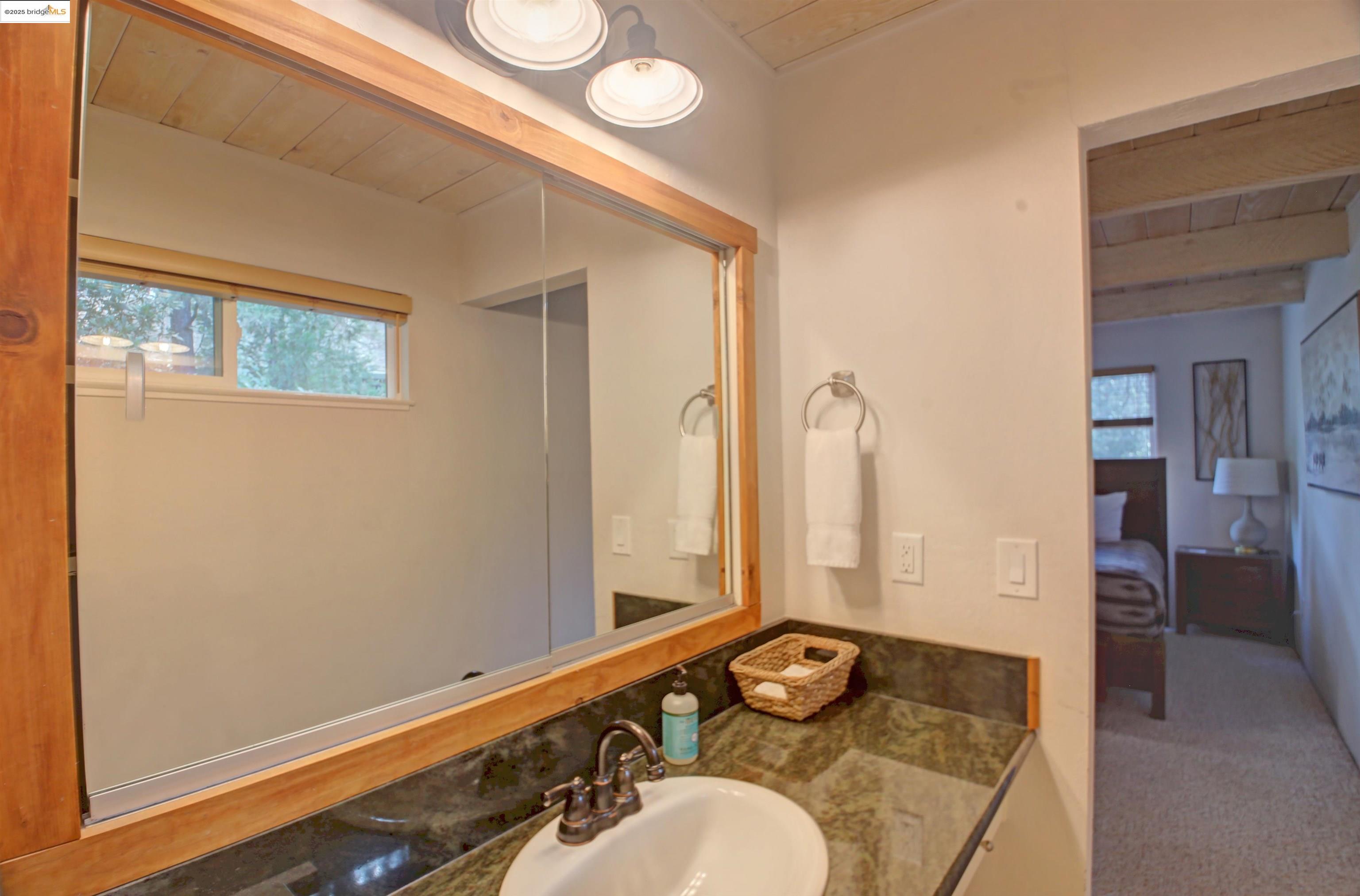11979 Myer Court Groveland, CA 95321 - Photo 28 of 39 a bathroom with a granite countertop sink and a mirror