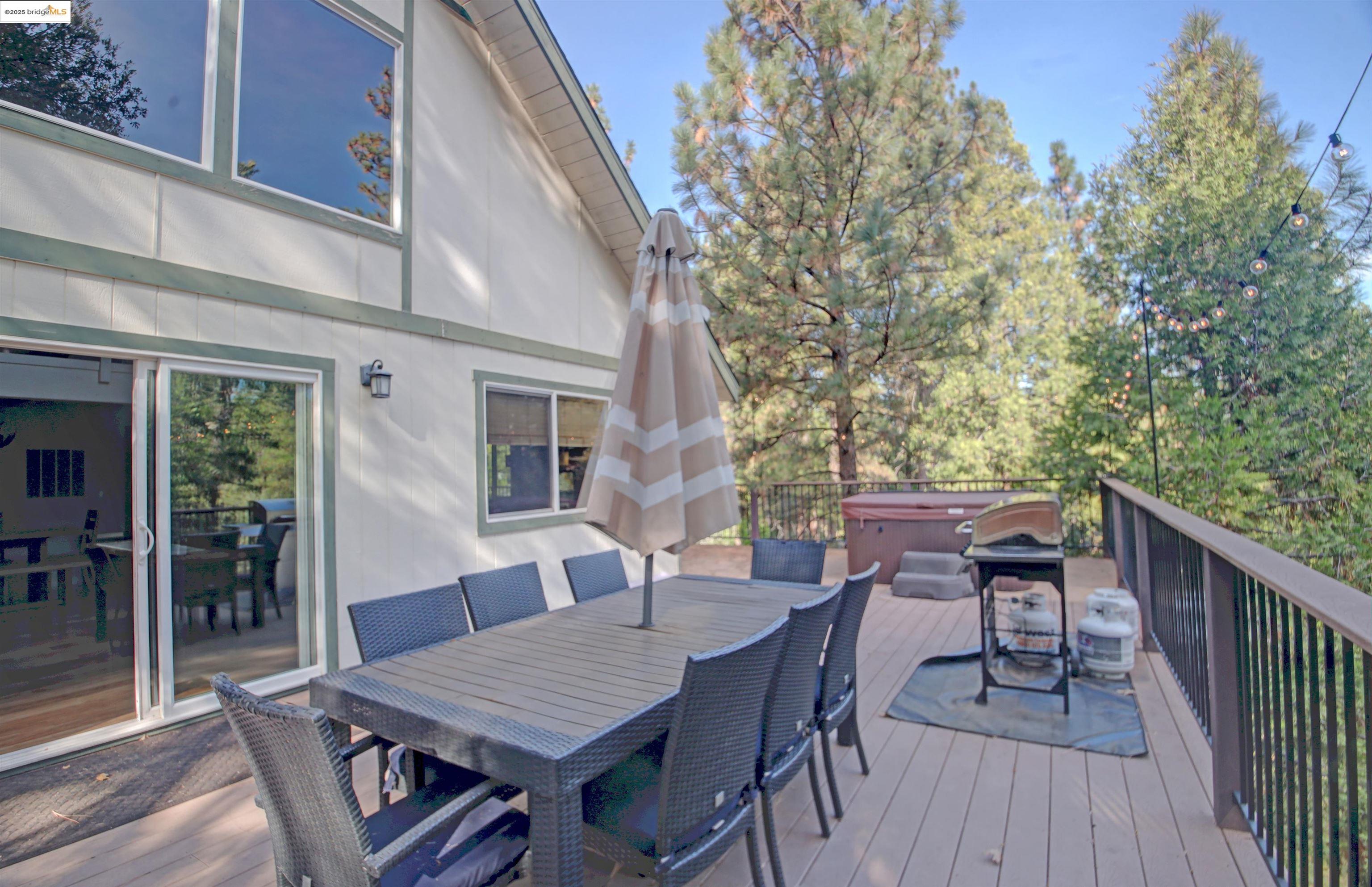 11979 Myer Court Groveland, CA 95321 - Photo 6 of 39 a view of a roof deck with table and chairs and wooden floor