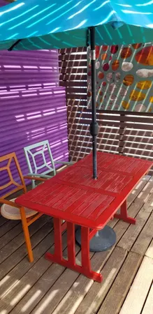 a view of a backyard with table and chairs under an umbrella