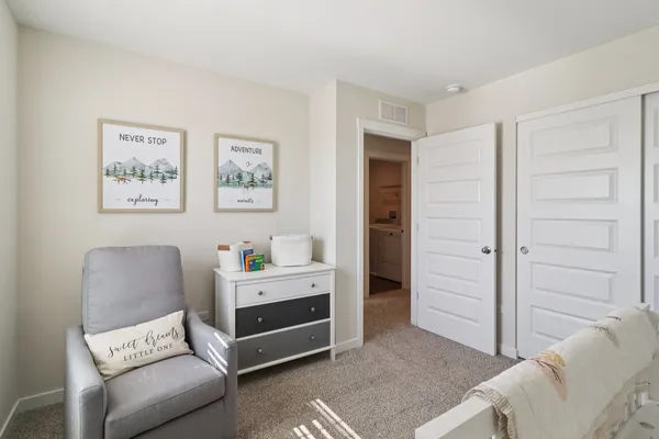 a bedroom with furniture and a painting