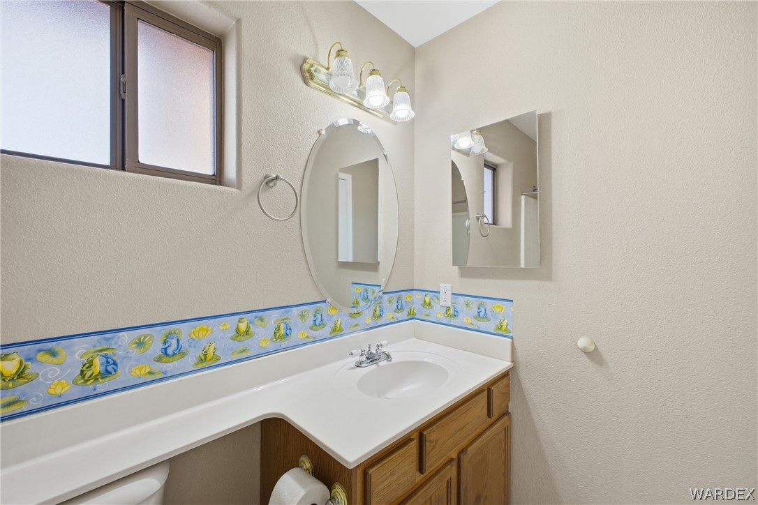 3918 North Eagle Rock Road Kingman, AZ 86409 - Photo 19 of 44 a bathroom with a sink and a mirror