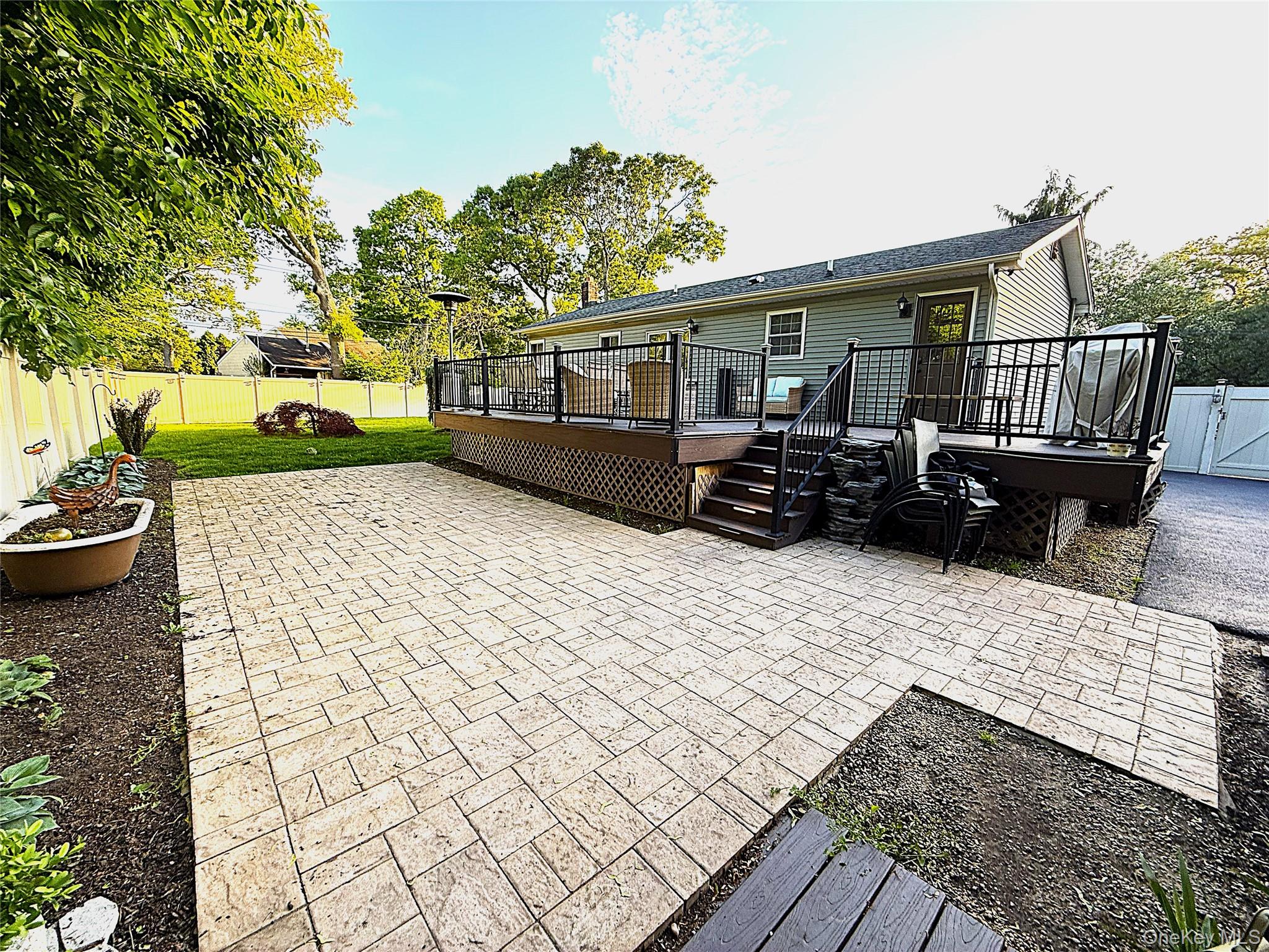 1 Heston Road Shirley, NY 11967 - Photo 28 of 32 Patio featuring paver flooring, bordered by a garden bed with hostas