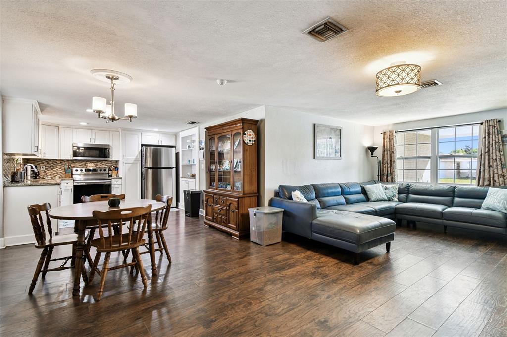 5831 1st Avenue New Port Richey, FL 34652 - Photo 6 of 22 a living room with furniture kitchen and a wooden floor