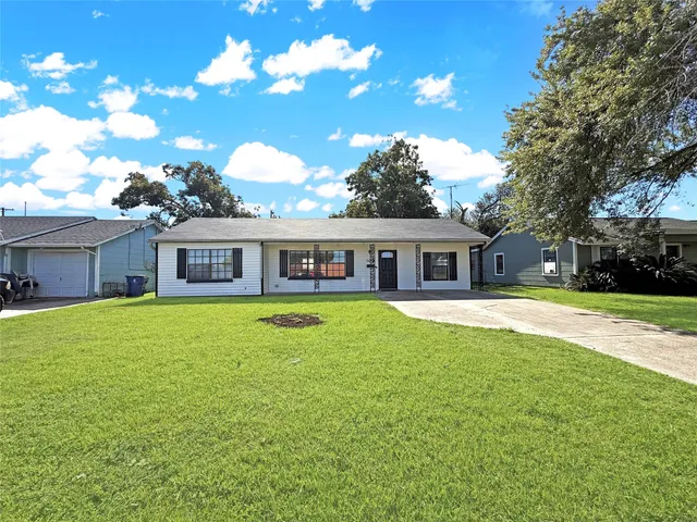 a front view of a house with a garden and porch