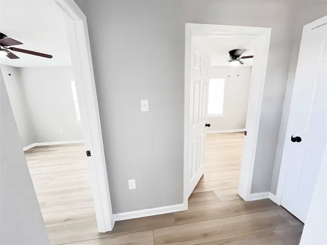 wooden floor with white walls