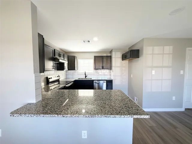 a kitchen with a sink and a refrigerator