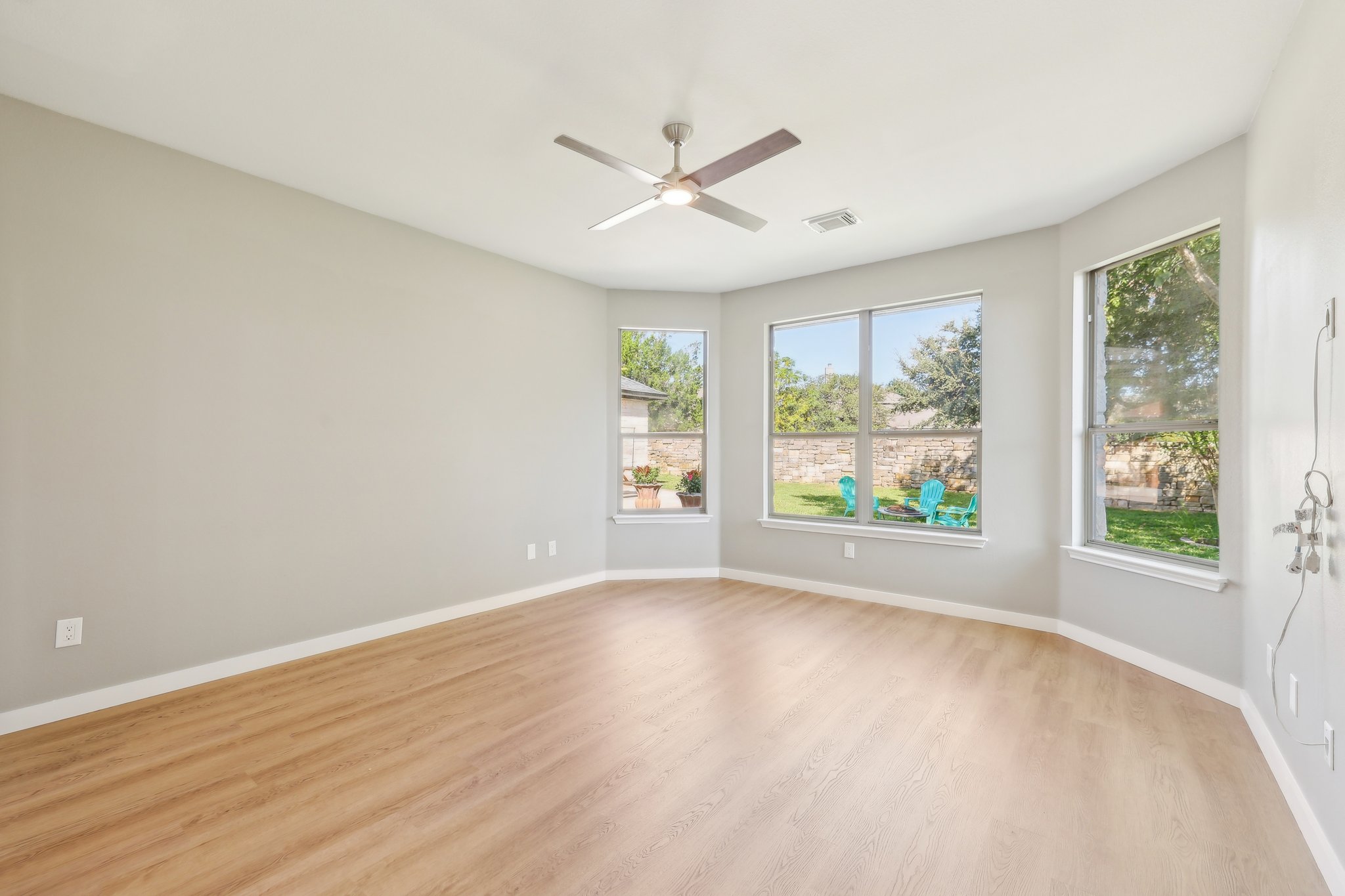 7324 Moon Rock Road Austin, TX 78739 - Photo 13 of 30 wooden floor in an empty room with a window