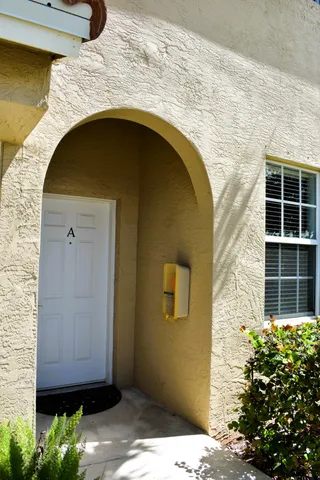 a front view of a house with plants