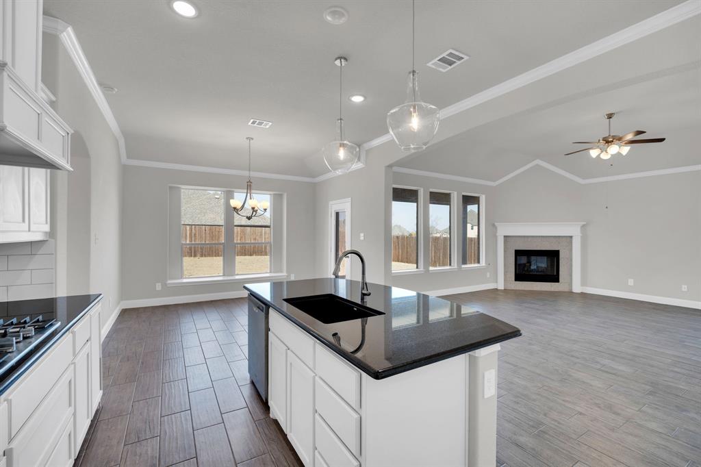 395 Haven Road Waxahachie, TX 75165 - Photo 11 of 40 a kitchen with granite countertop a sink cabinets and window